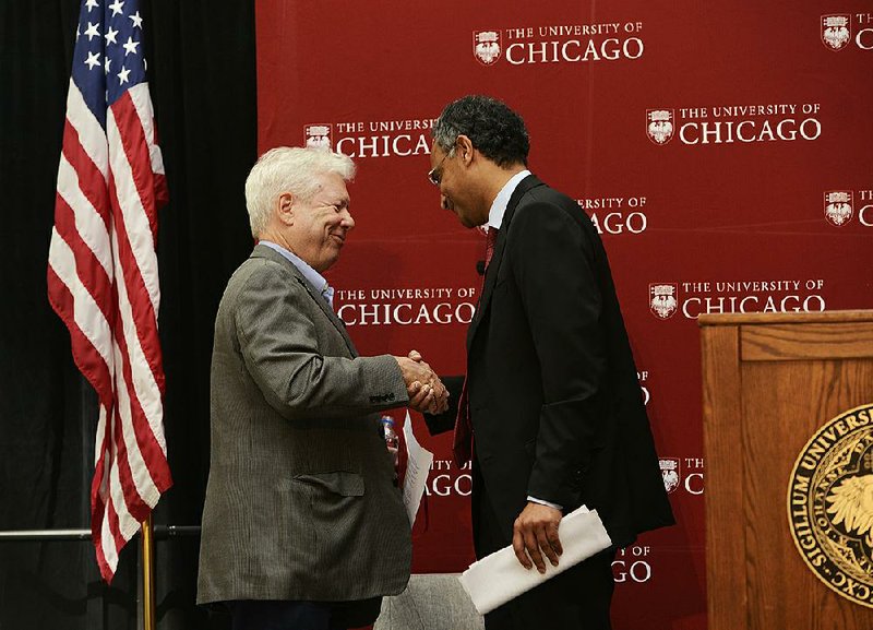 University of Chicago professor Richard Thaler (left) is congratulated by Booth School of Business Dean Madhar Rajan during a news conference Monday in Chicago announcing Thaler as the winner of the Nobel Prize for economics.