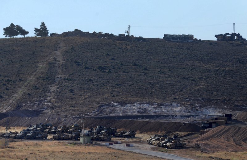 Turkey's forces' tanks and vehicles hold positions close to the border with Syria, near the town of Reyhanli, Turkey, Monday, Oct. 9, 2017. 
