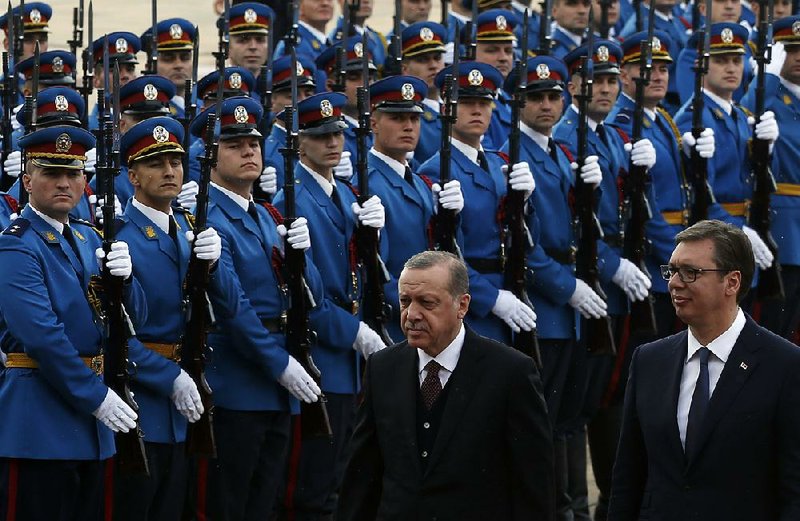 Turkish President Recep Tayyip Erdogan (front left) reviews an honor guard with Serbian President Aleksandar Vucic during a welcoming ceremony Tuesday for Erdogan in Belgrade. 