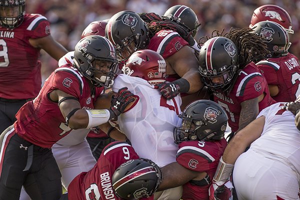 Arkansas running back Devwah Whaley is tackled by several South Carolina defenders during a game Saturday, Oct. 7, 2017, in Columbia, S.C.