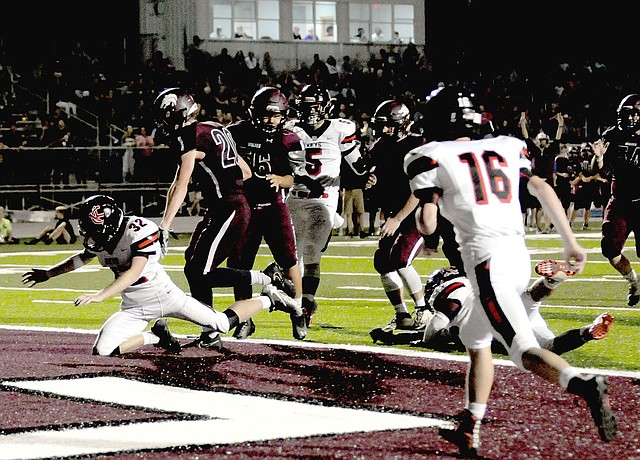 MARK HUMPHREY ENTERPRISE-LEADER Lincoln senior Braden Umberson scores the first touchdown on the new artificial turf in the south end zone at Wolfpack Stadium in the third quarter Friday, Sept. 8 on a 5-yard pass from quarterback Caleb Lloyd against Keys, Okla. Friday the Wolves defeated Berryville, 39-0. Game details are on Page 3B.