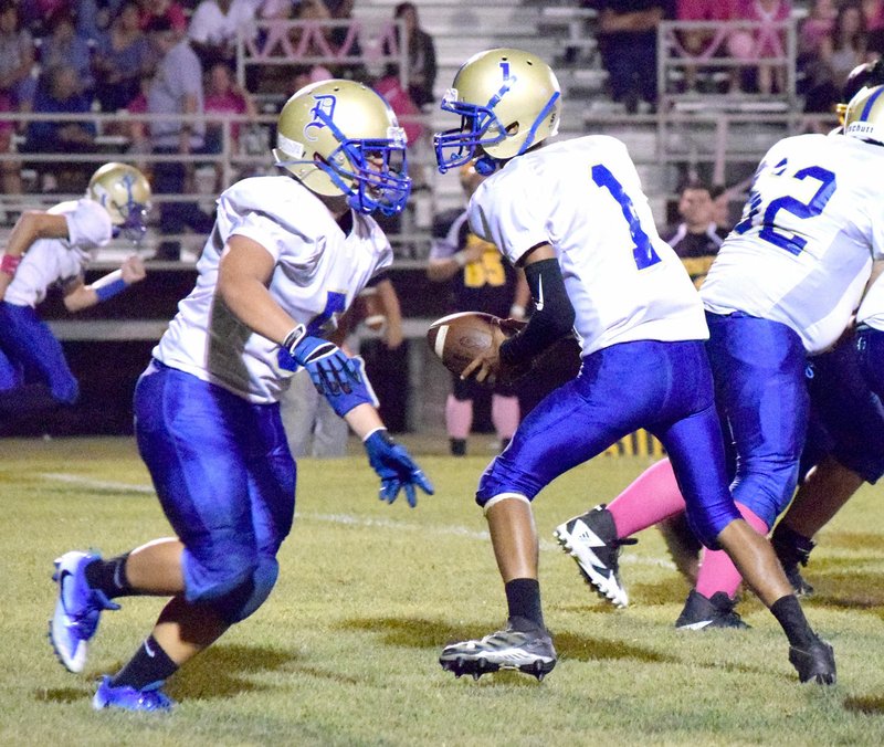 Photo by Mike Eckels Alex Lee (Decatur 5) moved in to receive a handoff from quarterback Joseph Armstrong (Decatur 1) during the Bulldogs-Hornets conference football contest at Mill Field in Hackett Oct. 6.