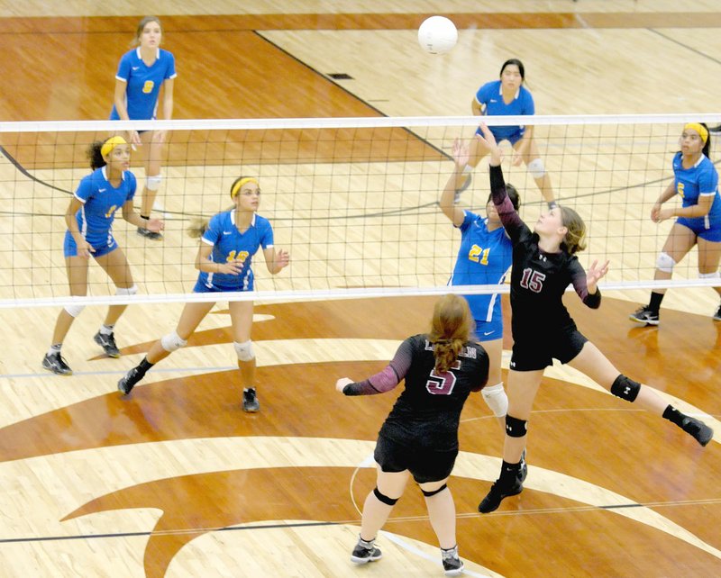 Photo by Mark Humphrey Lincoln sophomore Tanner Robb has the undivided attention of all six Decatur volleyball players, Desi Meek (left), Kelsey Woods, Kaylee Morales, Diana Reza and Jesse Mathline. Lincoln swept Decatur in three straight sets, 25-12, 25-15, 25-18, on Thursday, Sept. 28.