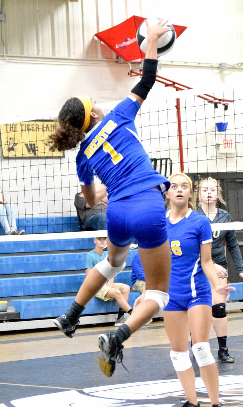 Photo by Mike Eckels Decatur's Desi Meek goes for a spike during the senior-high volleyball match between Decatur and West Fork in the volleyball gym at West Fork High School Oct. 5.