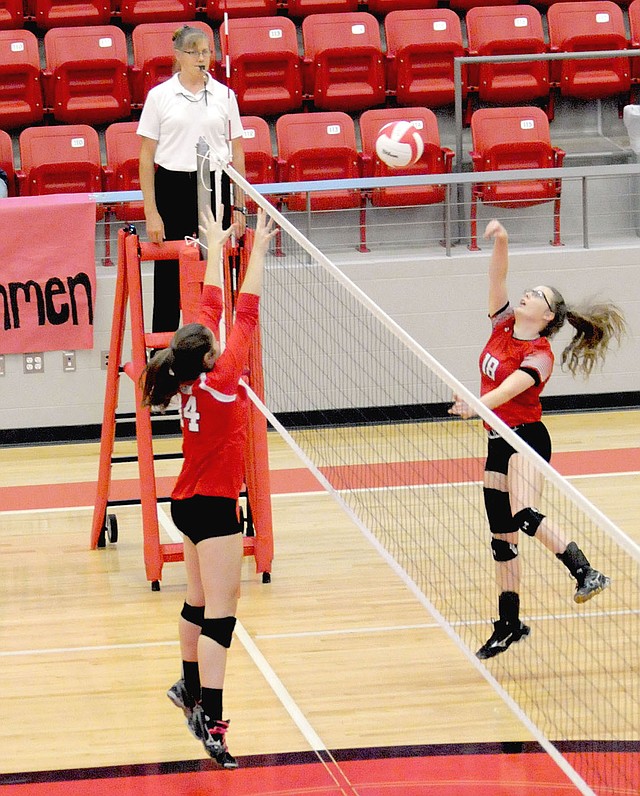 MARK HUMPHREY ENTERPRISE-LEADER Farmington senior Ella Wilson, shown going for a block against Clarksville, is the school's new All-time leader in block-kills with 88. Wilson recorded 3 block-kills in a loss to Huntsville, Monday, Oct. 2, to break the previous record held by Maria McPherson. The girls share the single season mark of 54 block-kills. Wilson has 34 thus far on the season and could potentially reach 100 if the Lady Cardinals qualify for state.