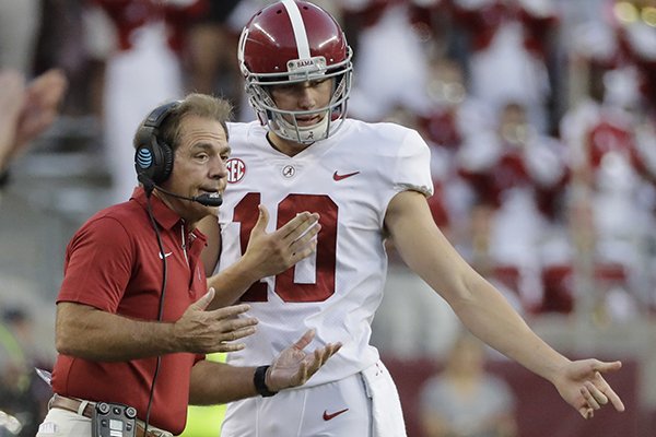 Alabama coach Nick Saban, left, talks with punter JK Scott during the first quarter of an NCAA college football game Saturday, Oct. 7, 2017, in College Station, Texas. (AP Photo/David J. Phillip)

