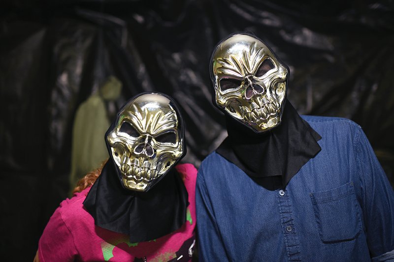 Volunteers Suzanne Magouryk, left, and David Thompson show off their masks at the Darkness Haunted House in Batesville. The haunted house to benefit Main Street Batesville will be open from 7-10 p.m. Oct. 13-14, 20-21, 27-28 and 30-31.