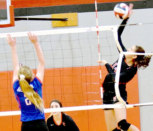Photo by Rick Peck McDonald County's Karla Barreda attempts a spike in the Lady Mustangs' loss to East Newton on Saturday at MCHS.
