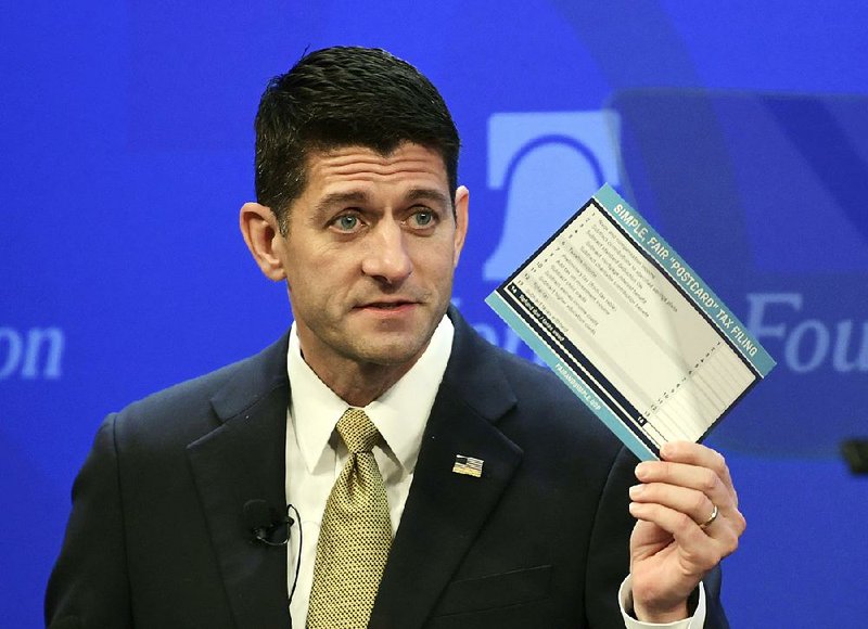 House Speaker Paul Ryan holds a copy of the proposed “simple tax” postcard Thursday during a speech at the conservative Heritage Foundation in Washington in which he criticized “profligate, big-government states.”