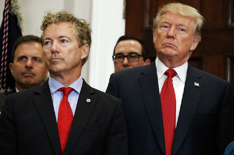 Sen. Rand Paul, R-Ky., stands with President Donald Trump after Trump signed an executive order on health care rules Thursday. Paul called Trump’s action “one of the most signifi cant free market health care reforms in a generation.” Trump gave Paul the pen he used to sign the order.