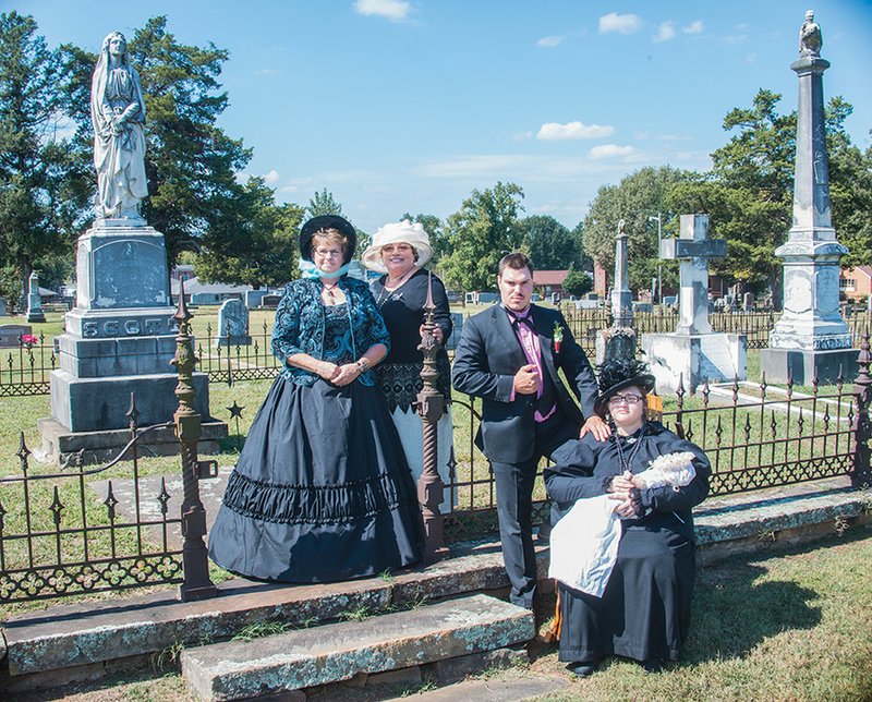 Participating in cemetery talks Oct. 28 at the Russellville Oakland Cemetery will be Stephanie Warwick, from left, cemetery director; Jeannie Stone, executive director of Traveling Arts Fiesta; Hunter Crissup, portraying Dr. Henry Blackwell Wiggs; and Charity Jewell, portraying Elizabeth Aspinwall “Bess” Wiggs. Bess Wiggs wrote a six-stanza Victorian poem after the death of her young son, Henry, who is also buried in the cemetery. Jewell will read part of the poem during the cemetery talks.