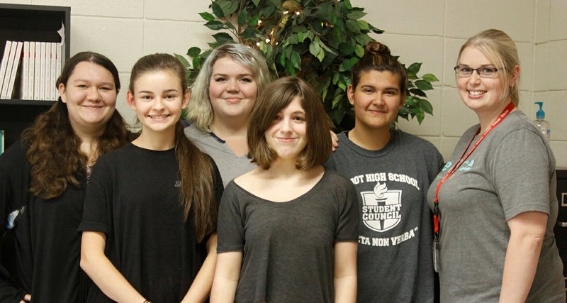 Cabot High School students, from left, Miranda Thomson, Hannah Tauriello, Caitlyn Govern, Gabrielle Taunton and Nicole Hartsel stand alongside club sponsor Danielle Lovellette at a weekly Girls Who Code meeting. It’s important to encourage girls to go for it when it comes to engineering and technology, Lovellette said, because it helps build confidence.