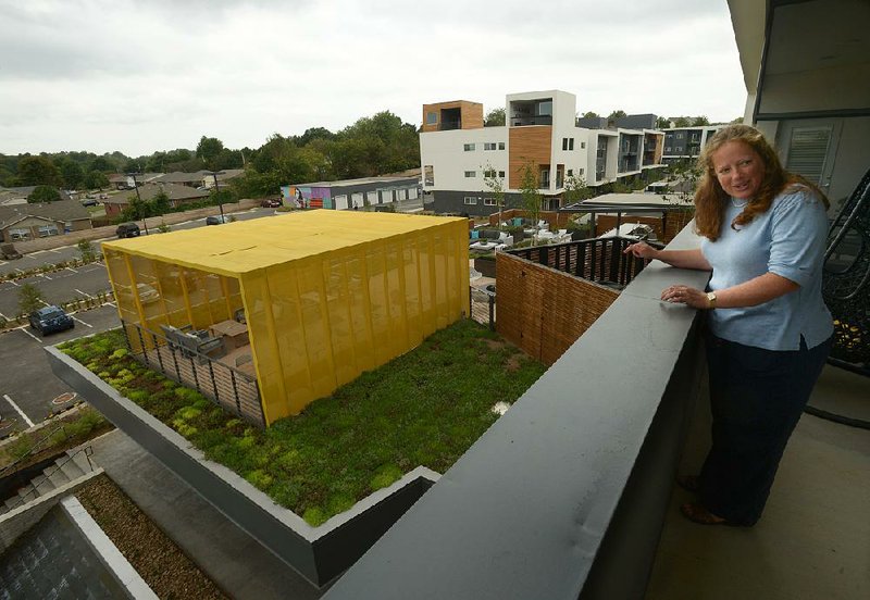 Sarah King, a spokesman for Fayetteville-based Specialized Real Estate Group, shows a community roof-top space for an apartment balcony at Uptown Fayetteville Apartments. 