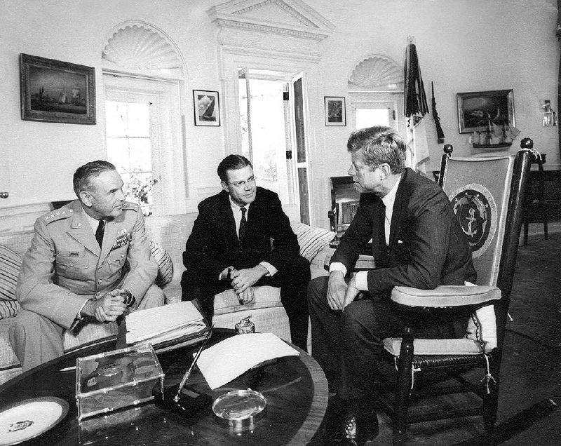 This Oct. 2, 1963, photo shows President John F. Kennedy (right) meeting with Joint Chiefs Chairman Gen. Maxwell D. Taylor (left) and Defense Secretary of Defense Robert S. McNamara in the Oval Office of the White House.