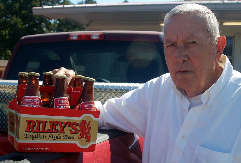 William Lyon of Fordyce, founder of Arkansas Brewing Co., displays a six pack of Riley’s Red Lyon, one of four beers he produced at his brewery in Little Rock from 1983 to 1986. 