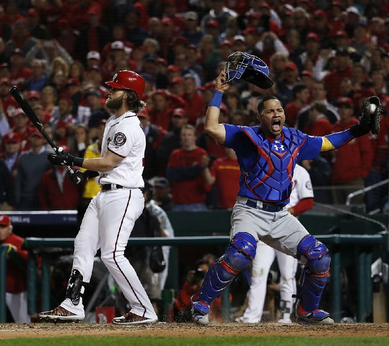 Chicago Cubs catcher Willson Contreras begins to celebrate after the Washington Nationals’ Bryce Harper struck out swinging in the ninth inning to end Game 5 of the National League division series at Nationals Park in Washington on Thursday night. The Cubs advanced to the NLCS for the third consecutive season with a 9-8 victory. Washington has been eliminated in the NLDS four times in six years.