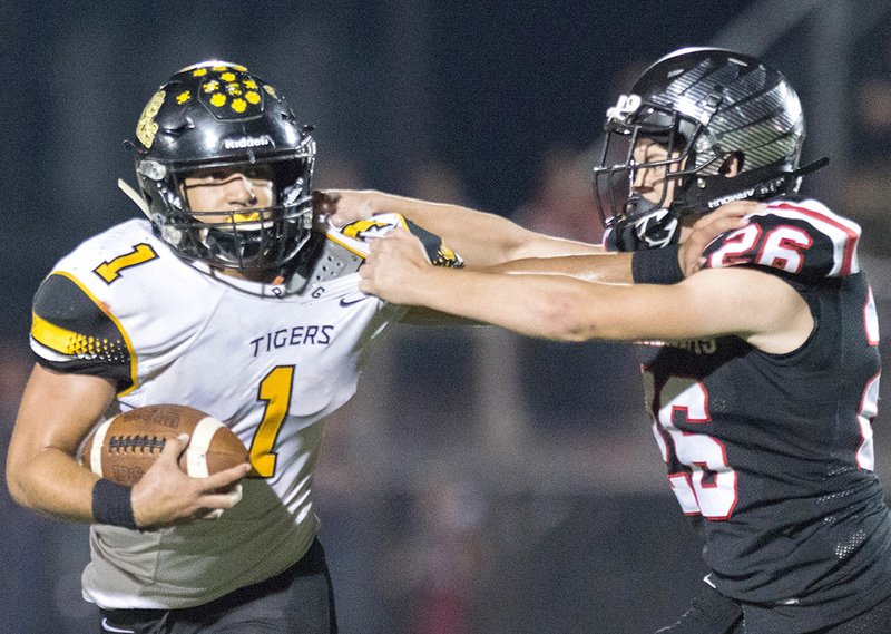 NWA Democrat-Gazette/CHARLIE KAIJO Pea Ridge linebacker Gavin Warden (26) latches on to Prairie Grove running back Anthony Johnson on Friday at Blackhawk Stadium in Pea Ridge.