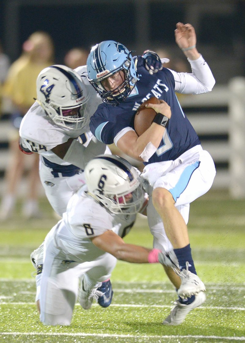 NWA Democrat-Gazette/ANDY SHUPE Bentonville West linebackers Kobe Anderson (6) and Kendall Young (24) bring down Springdale Har-Ber quarterback Grant Allen on Friday at Wildcat Stadium in Springdale.