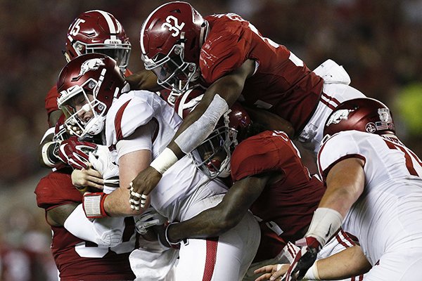 Arkansas quarterback Cole Kelley is tackled by Alabama players during the first half an NCAA college football game, Saturday, Oct. 14, 2017, in Tuscaloosa, Ala. (AP Photo/Brynn Anderson)

