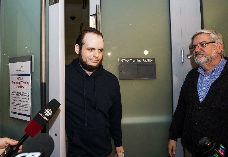 Joshua Boyle speaks to reporters Friday after arriving at Pearson International Airport in Toronto.