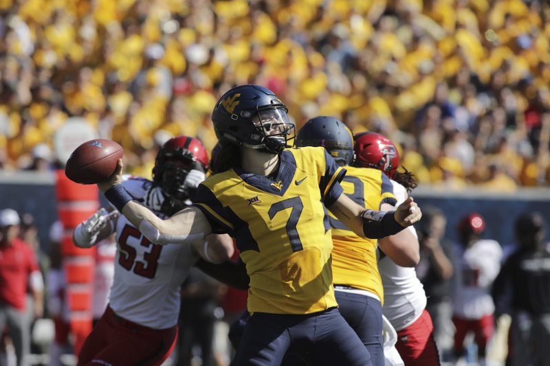 West Virginia quarterback Will Grier (7) attempts a pass during the first half of an NCAA college football game against Texas Tech, Saturday, Oct. 14, 2017, in Morgantown, W.Va. (AP Photo/Raymond Thompson)