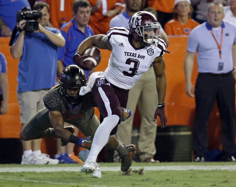 Texas A&M's Christian Kirk (3) returns a punt as Florida defensive back C.J. McWilliams can't make the tackle during the first half of an NCAA college football game, Saturday, Oct. 14, 2017, in Gainesville, Fla. (AP Photo/John Raoux)