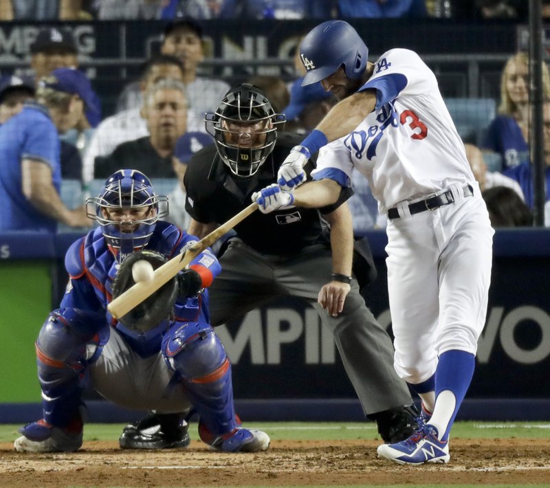 Los Angeles Dodgers' Chris Taylor hits a home run against the Chicago Cubs during the sixth inning of Game 1 of baseball's National League Championship Series in Los Angeles, Saturday, Oct. 14, 2017. (AP Photo/Alex Gallardo)