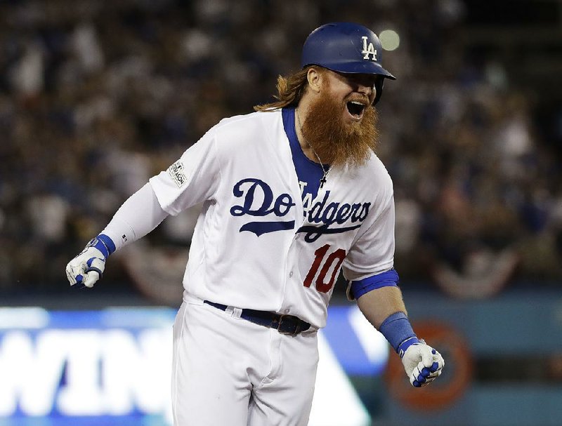 Los Angeles Dodgers’ Justin Turner celebrates after his game-winning three-run home run off Chicago Cubs pitcher John Lackey with two outs in the bottom of the ninth inning Sunday night in Game 2 of the NL Championship Series. The Dodgers beat the Cubs 4-1 to take a 2-0 series lead.