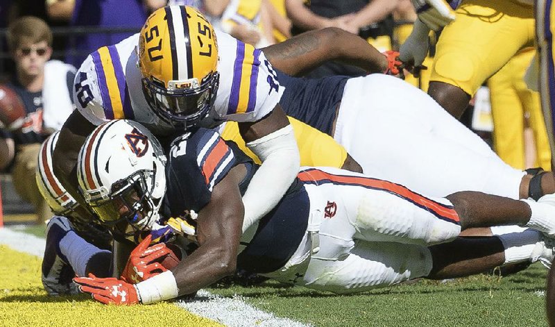 Auburn running back Kerryon Johnson scores as LSU linebacker Devin White defends in the first half Saturday in Baton Rouge.
