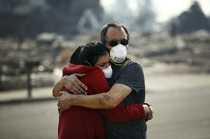 Howard Lasker (right) comforts his daughter, Gabrielle, who on Sunday was seeing their Santa Rosa, Calif., home for the first time since a wildfire swept through it.