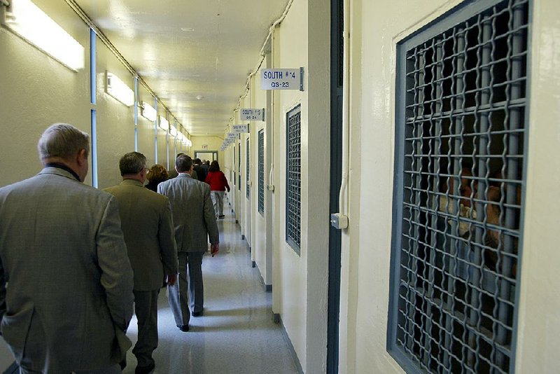 In this December 2002 photo, prison board members and other officials view the isolation wing at the Cummins Unit at Varner. The Arkansas Department of Correction wants to add up to 400 more lockdown cells to the more than 2,000 already in use.
