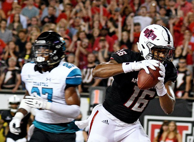 Arkansas State receiver Blake Mack (16) pulls down a 10-yard touchdown catch in front of Coastal Carolina’s Amir Howard during the second quarter of the Red Wolves’ 51-17 victory over the Chanticleers on Saturday in Jonesboro. Mack was ASU’s leading receiver, catching 6 passes for 63 yards and 2 touchdowns.  
