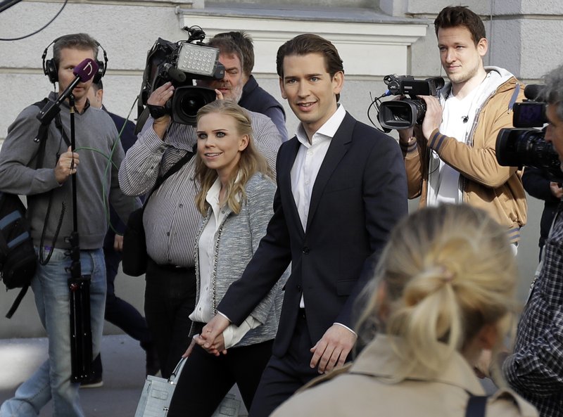 Foreign Minister Sebastian Kurz, head of Austrian People's Party, and his girlfriend Susanne Thier arrive to the polling station to casts their vote in Vienna, Austria, Sunday, Oct. 15, 2017, when about 6.4 million people are eligible to vote in the national elections. 