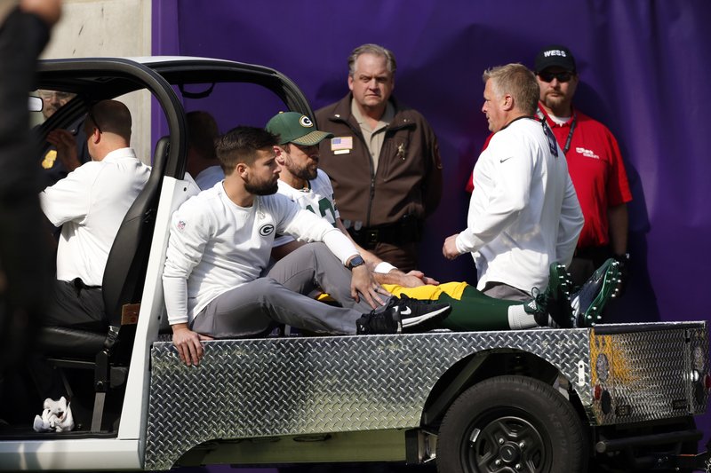 Green Bay Packers quarterback Aaron Rodgers (12) rides a cart to the locker room after being injured against the Minnesota Vikings in the first half of an NFL football game in Minneapolis, Sunday, Oct. 15, 2017. 