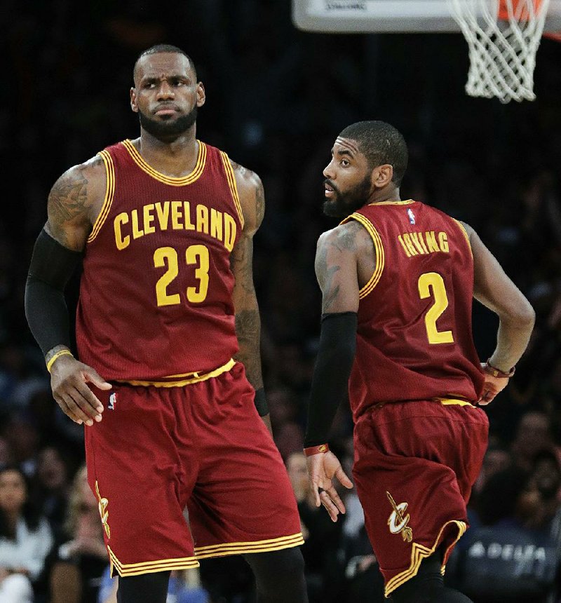 The Cavaliers’ LeBron James (left) and Kyrie Irving were teammates last season but will be rivals tonight after Irving was traded to the Celtics. Cleveland hosts Boston at 7 p.m. in the NBA season opener. Golden State hosts Houston in today’s other game.