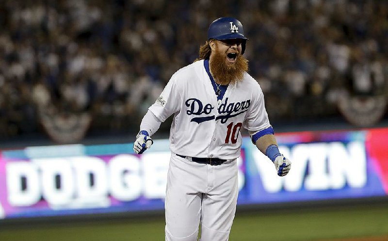 Los Angeles Dodgers’ Justin Turner celebrates after his game-winning three-run home run off Chicago Cubs pitcher John Lackey with two outs in the bottom of the ninth inning Sunday night in Game 2 of the NL Championship Series. The Dodgers beat the Cubs 4-1 to take a 2-0 series lead.