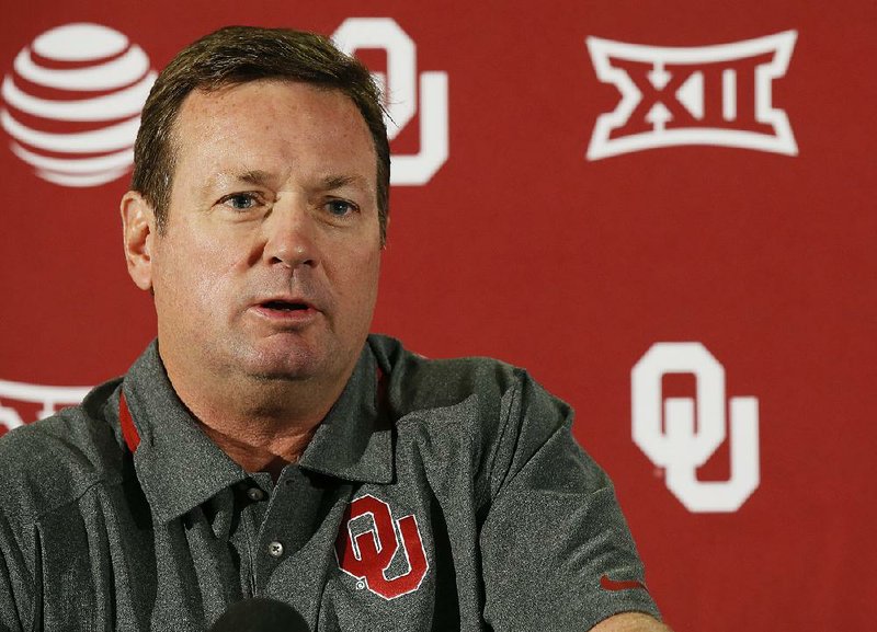 In this Sept. 12, 2016, file photo, Oklahoma head coach Bob Stoops answers a question during an NCAA college football news conference in Norman, Okla. 