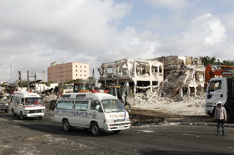 Ambulances carrying wounded victims pass the scene of Saturday’s truck bombing in Mogadishu, Somalia, heading to the airport Monday for an airlift by Turkish air ambulance to treatment in Turkey. The toll from two blasts continues to climb.