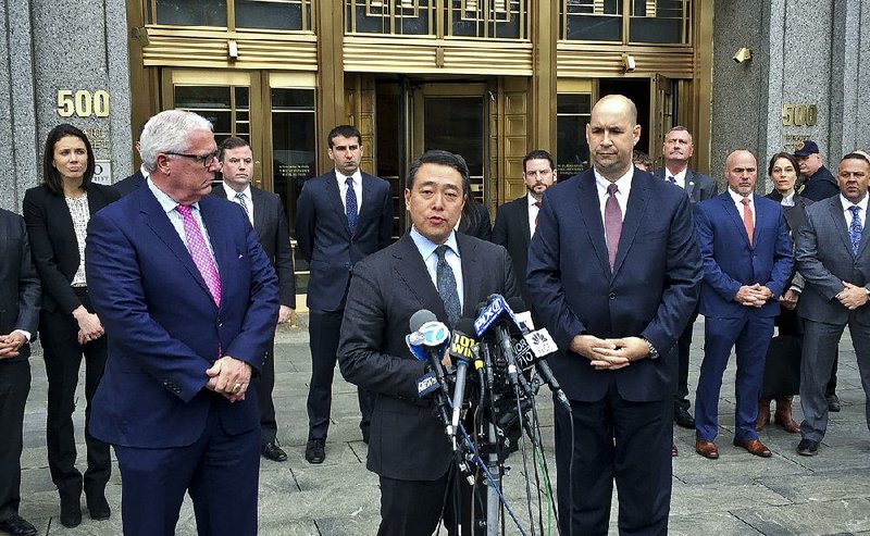 Flanked by New York Deputy Police Commissioner Robert Miller (left) and New York FBI Assistant Director in Charge William Sweeney (right), acting U.S. Attorney Joon Kim speaks Monday outside Manhattan federal court after a jury convicted Ahmad Khan Rahimi of carrying out bombings.
