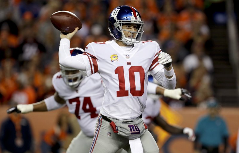 New York Giants quarterback Eli Manning throws a pass during the first half of an NFL football game against the Denver Broncos, Sunday, Oct. 15, 2017, in Denver. 