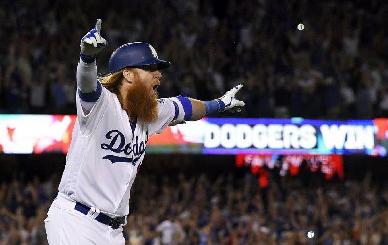 The ball from the game-winning home run hit by Justin Turner of the Los Angeles Dodgers in Game 2 of the National League Championship Series against the Chicago Cubs on Sunday was just one of many caught by Dodgers fan Keith Hupp.