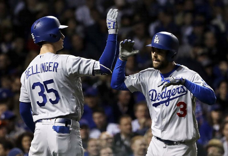 Los Angeles shortstop Chris Taylor is congratulated by teammate Cody Bellinger after hitting a home run during the third inning of the Dodgers’ 6-1 victory over the Chicago Cubs on Tuesday in Game 3 of the National League Championship Series at Wrigley Field in Chicago.
