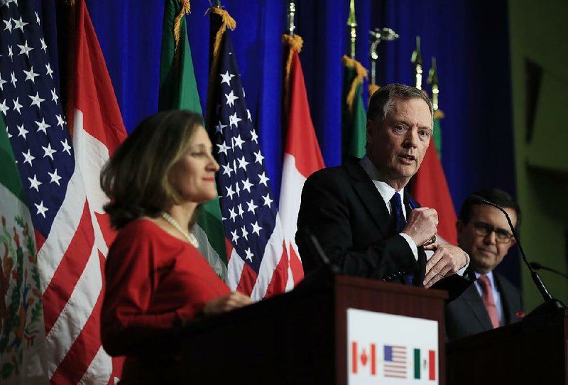 U.S. Trade Representative Robert Lighthizer, flanked by Canadian Minister of Foreign Affairs Chrystia Freeland and Mexico’s Secretary of Economy Ildefonso Guajardo Villarrea (right), speaks Tuesday at the conclusion of the fourth round of negotiations for a new North American Free Trade Agreement in Washington.   
