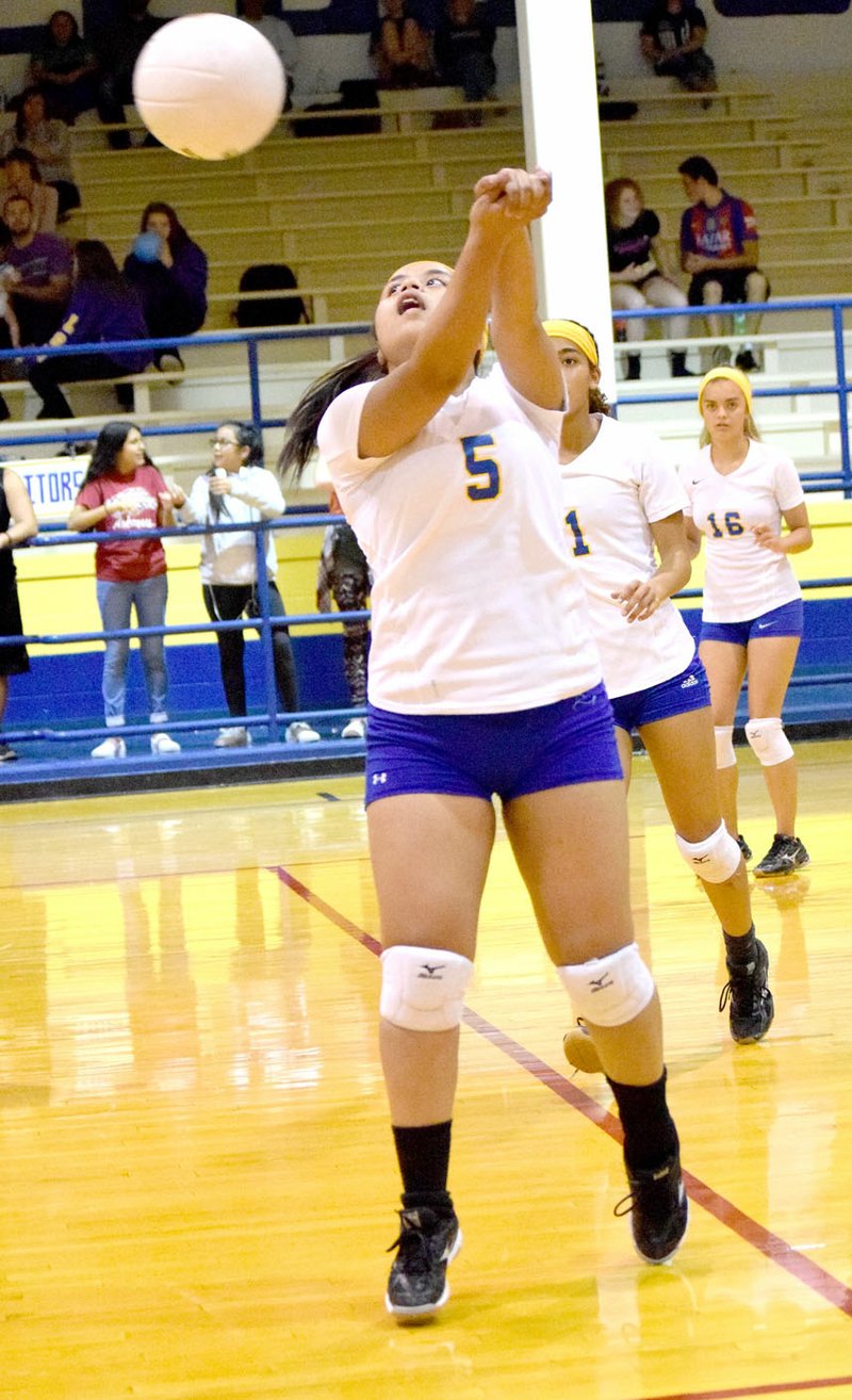 Photo by Mike Eckels Mathline Jesse (Decatur 5) bumped the ball back into Lady Elks territory during the second set of the Decatur-Elkins senior volleyball match at Peterson Gym in Decatur Oct. 12.