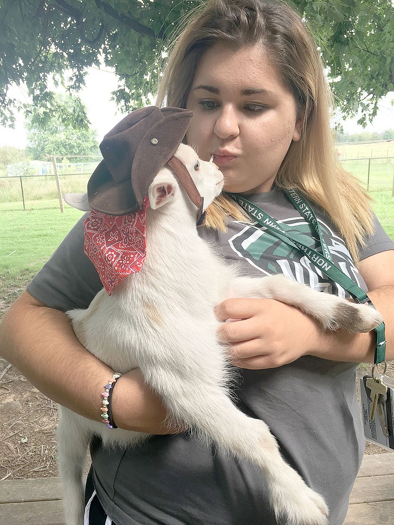SUBMITTED PHOTO Baylie Smith, a member of First Presbyterian Church in Prairie Grove, and her baby goat &quot;Reggie.&quot; The church will have a Blessing of the Animals on Oct. 21.