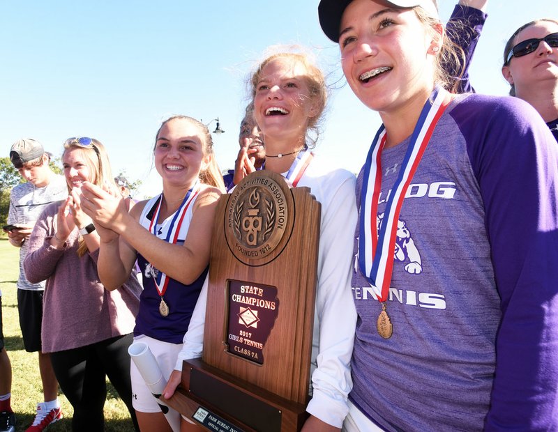 Members of the Fayetteville girls tennis team pose with the trophy after winning the Class 7A team title Tuesday in Bentonville. It was the Lady Bulldogs’ first state title since 1982.