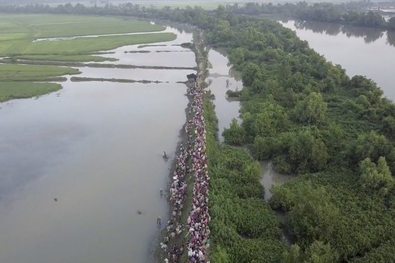 In this image made from Oct. 16, 2017, video released by UNHCR, thousands of Rohingya refugees arrive in Anjuman Para, Bangladesh, from Myanmar. Over 500,000 Rohingya Muslim refugees have fled violence in Myanmar and arrived in Bangladesh over the past seven weeks. (Roger Arnold/UNHCR via AP)