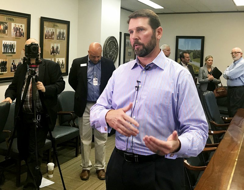 Arkansas Department of Transportation Director Scott Bennett speaks to reporters after discussing a possible road funding proposal with the state Highway Commission in Little Rock on Wednesday, Oct. 18, 2017. 