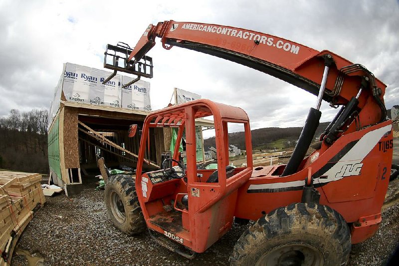 A forklift is parked in front of a house under construction in Zelienople, Pa., in March. 