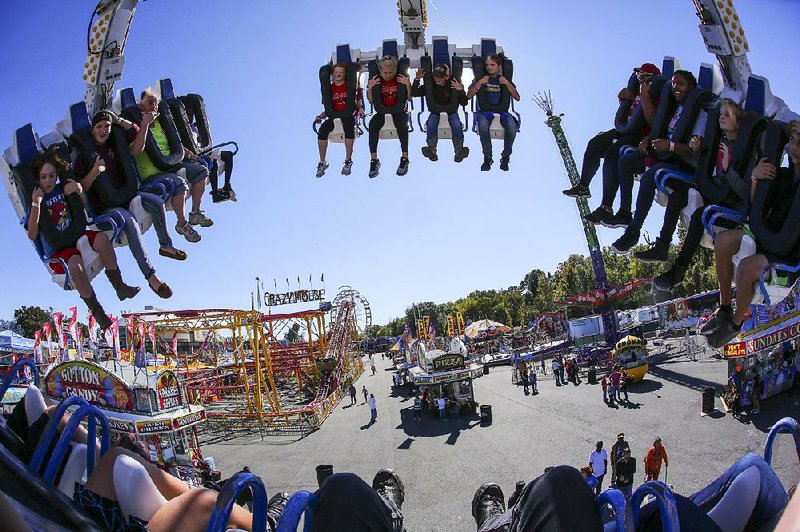 FILE PHOTO: Arkansas Democrat-Gazette/BENJAMIN KRAIN --10/18/2017--
Fairgoers fly over the midway on the Freak Out ride Wednesday, Oct. 18. 2017, at the State Fair.